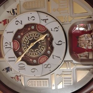 Elegant Musical Wall Clock with Rotating Figurines
